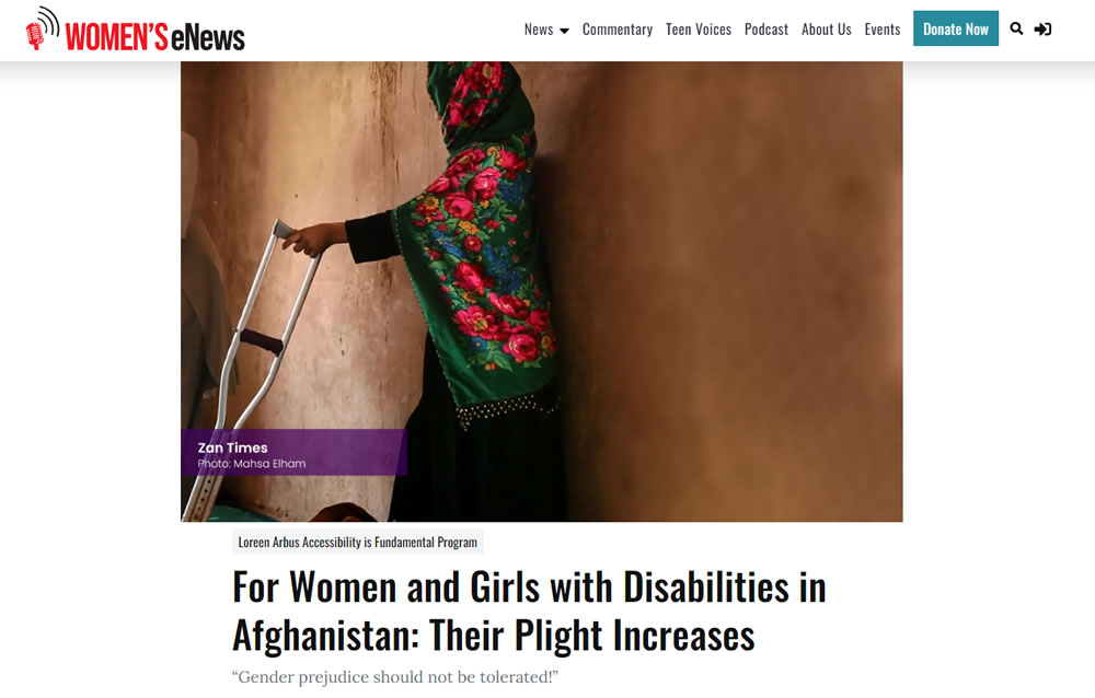 Image of a woman from Afghanistan leaning against a wall, holding a crutch.
