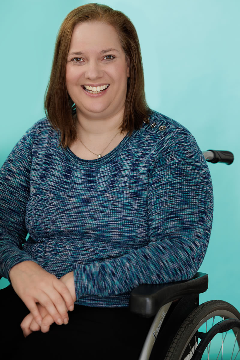 Dawn Grabowski in a wheelchair wearing a blue sweater