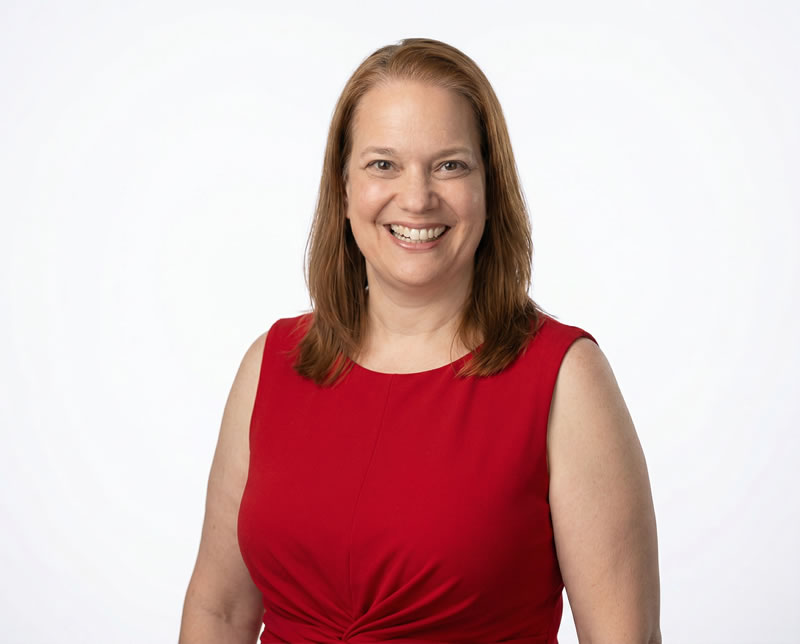 Dawn wearing a red sleeveless dress on white background